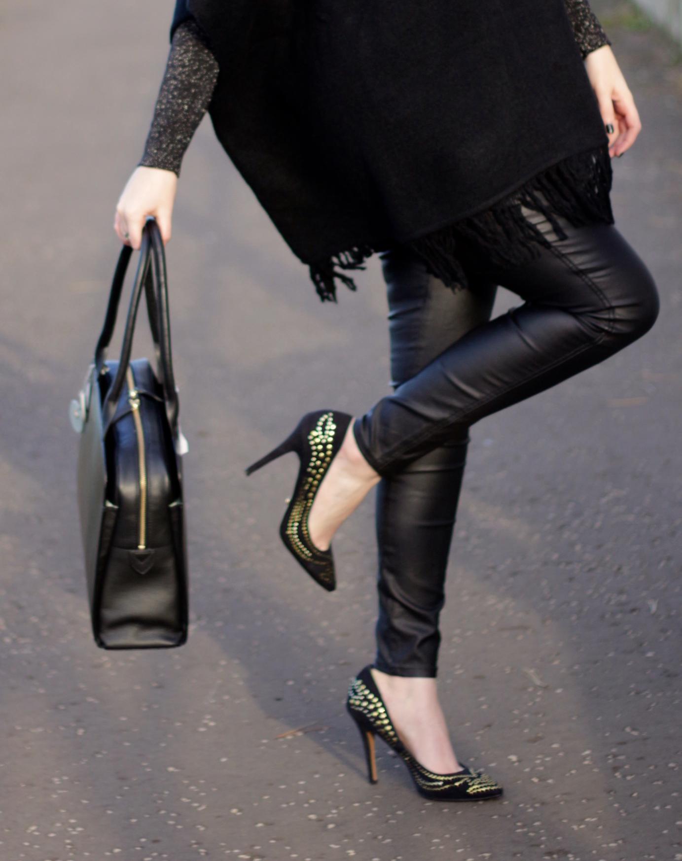 black poncho and leather jeans outfit of the day