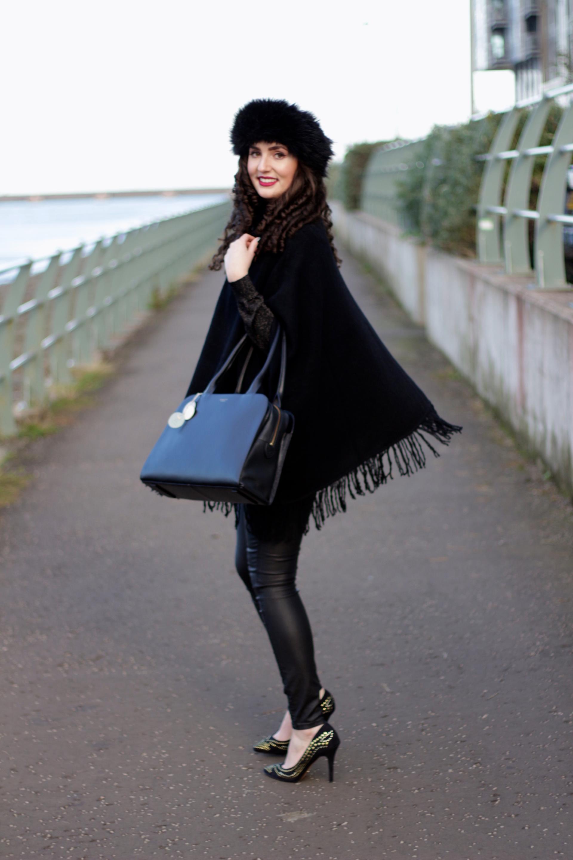 black poncho and leather jeans outfit of the day